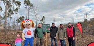 Olaf Klose (Vorstandsmitglied Sparkasse Leipzig), Dr. Manfred Wilde (Oberbürgermeister Stadt Delitzsch), Kai Emanuel (Landrat Landkreis Nordsachsen), Henrik Lindner (Geschäftsführer Stiftung Wald für Sachsen), Maskottchen Glückspilz Winni (Sparkasse Leipzig) und die Enkelin von Dr. Manfred Wilde. Foto: Sparkasse Leipzig